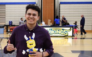 Student posing by announcers' desk